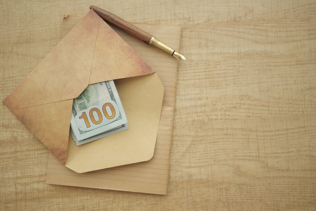 A formal goodwill letter sitting in an envelope next to a fountain pen on a wooden desk.