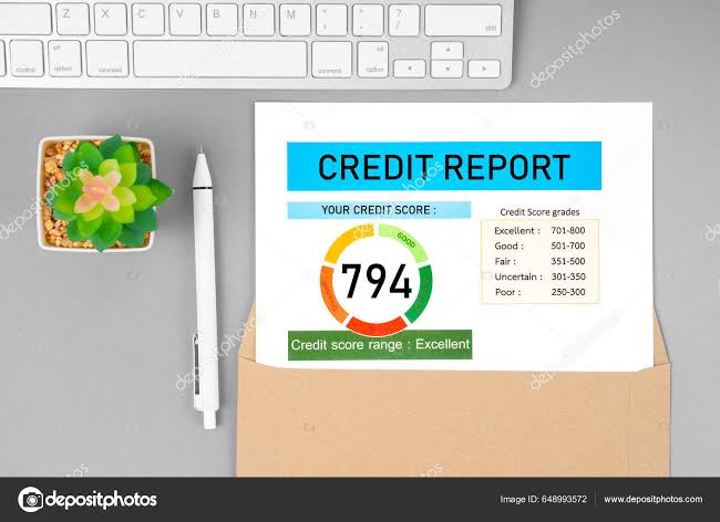 A credit report document sitting on a desk with a keyboard and pen